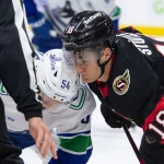 Nov 23, 2024; Ottawa, Ontario, CAN; Vancouver Canucks center Aatu Raty (54) faces off against Ottawa Senators center Tim Stutzle (18) in the second period at the Canadian Tire Centre.