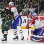 Feb 2, 2026; Saint Paul, Minnesota, USA; Minnesota Wild right wing Ryan Hartman (38) is hit by Montreal Canadiens center Joe Veleno (90) while trying to deflect a shot in the second period at Grand Casino Arena.