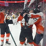 Apr 22, 2026; Philadelphia, Pennsylvania, USA; Philadelphia Flyers left wing Noah Cates (27) celebrates his goal with right wing Tyson Foerster (71), center Trevor Zegras (46) and right wing Porter Martone (94) against the Pittsburgh Penguins during the third period in game three of the first round of the 2026 Stanley Cup Playoffs at Xfinity Mobile Arena.