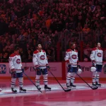 Dec 21, 2025; Pittsburgh, Pennsylvania, USA; The Montreal Canadiens starting line up (L to R) including goaltender Jakub Dobes (75) and right wing Cole Caufield (13) and center Nick Suzuki (14) and defenseman Mike Matheson (8) and defenseman Noah Dobson (53) and right wing Zachary Bolduc (76) stand for the Canadian national anthem against the Pittsburgh Penguins at PPG Paints Arena. Mandatory Credit: Charles LeClaire-Imagn Images