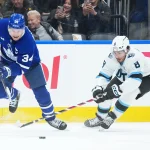 Nov 5, 2025; Toronto, Ontario, CAN; Toronto Maple Leafs center Auston Matthews (34) battles for the puck with Utah Mammoth center Nick Schmaltz (8) during the first period at Scotiabank Arena. Mandatory Credit: Nick Turchiaro-Imagn Images