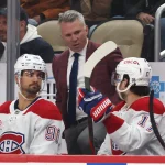 Dec 21, 2025; Pittsburgh, Pennsylvania, USA; Montréal Canadiens head coach Martin St. Louis (middle) talks to center Oliver Kapanen (91) and right wing Josh Anderson (17) on the bench against the Pittsburgh Penguins during the third period at PPG Paints Arena. Mandatory Credit: Charles LeClaire-Imagn Images