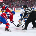 May 16, 2026; Montreal, Quebec, CAN; NHL linesman Scott Cherrey (50) drops the puck at a face-off between Montreal Canadiens center Jake Evans (71) and Buffalo Sabres right wing Josh Doan (91) during the second period in game six of the second round of the 2026 Stanley Cup Playoffs at Bell Centre. Mandatory Credit: David Kirouac-Imagn Images