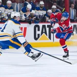 May 16, 2026; Montreal, Quebec, CAN; Montreal Canadiens defenseman Lane Hutson (48) shoots the puck against Buffalo Sabres right wing Josh Doan (91) during the third period in game six of the second round of the 2026 Stanley Cup Playoffs at Bell Centre.