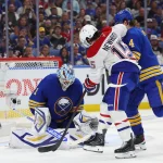 May 18, 2026; Buffalo, New York, USA; Buffalo Sabres goaltender Ukko-Pekka Luukkonen (1) makes a save on Montréal Canadiens center Alex Newhook (15) during the third period in game seven of the second round of the 2026 Stanley Cup Playoffs at KeyBank Center.