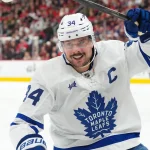 Dec 4, 2025; Raleigh, North Carolina, USA; Toronto Maple Leafs center Auston Matthews (34) celebrates his goal against the Carolina Hurricanes during the second period at Lenovo Center. Mandatory Credit: James Guillory-Imagn Images