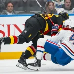 Oct 25, 2025; Vancouver, British Columbia, CAN; Vancouver Canucks forward Kiefer Sherwood (44) checks Montreal Canadiens defenseman Lane Hutson (48) in the second period at Rogers Arena.