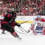 May 21, 2026; Raleigh, North Carolina, USA; Montreal Canadiens goaltender Jakub Dobes (75) defends the net against a shot by Carolina Hurricanes left wing Jordan Martinook (48) during the first period in game one of the Eastern Conferene Final of the 2026 Stanley Cup Playoffs at Lenovo Center.