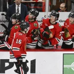 Apr 9, 2026; Chicago, Illinois, USA; Chicago Blackhawks center Anton Frondell (16) celebrates his goal against the Carolina Hurricanes with teammates during the third period at the United Center. Mandatory Credit: Matt Marton-Imagn Images
