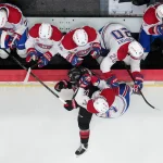 May 21, 2026; Raleigh, North Carolina, USA; Montreal Canadiens center Jake Evans (71) checks Carolina Hurricanes center Logan Stankoven (22) into the boards during the third period in game one of the Eastern Conferene Final of the 2026 Stanley Cup Playoffs at Lenovo Center.