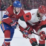 25 mai 2026 ; Montréal, Québec, Canada ; Le défenseur des Canadiens de Montréal, Lane Hutson (48), et le centre des Hurricanes de la Caroline, Jordan Staal (11), se disputent le palet au cours de la deuxième période du troisième match de la finale de la Conférence de l\'Est des séries éliminatoires de la Coupe Stanley 2026, au Centre Bell.