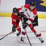 Jordan Tourigny's stomp could cost him draft rounds Jan 25, 2023; Langley, BC, CANADA; CHL Top Prospects team white forward Ethan Miedema (19) controls the puck against against CHL Top Prospects team red defenseman Jordan Tourigny (49) during the third period in the 2023 CHL Top Prospects ice hockey game at Langley Events Centre. Mandatory Credit: Anne-Marie Sorvin-Imagn Images