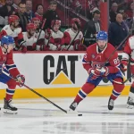 May 25, 2026; Montreal, Quebec, CAN; Montreal Canadiens defenseman Lane Hutson (48) takes the puck from left wing Alexandre Texier (85) in front of Carolina Hurricanes defenseman Sean Walker (26) during overtime in game three of the Eastern Conference Final of the 2026 Stanley Cup Playoffs at Bell Centre. Mandatory Credit: Eric Bolte-Imagn Images
