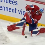May 27, 2026; Montreal, Quebec, CAN; Montreal Canadiens goaltender Jakub Dobes (75) clears the puck against the Carolina Hurricanes during the third period in game four of the Eastern Conference Final of the 2026 Stanley Cup Playoffs at Bell Centre. Mandatory Credit: Eric Bolte-Imagn Images