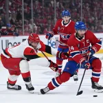 May 27, 2026; Montreal, Quebec, CAN; Montreal Canadiens center Nick Suzuki (14) skates past Carolina Hurricanes center Jordan Staal (11) during the first period in game four of the Eastern Conference Final of the 2026 Stanley Cup Playoffs at Bell Centre. Mandatory Credit: David Kirouac-Imagn Images