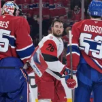 May 25, 2026; Montreal, Quebec, CAN; Carolina Hurricanes defenseman Sean Walker (26) talks to Montreal Canadiens goaltender Jakub Dobes (75) after a collision during the second period in game three of the Eastern Conference Final of the 2026 Stanley Cup Playoffs at Bell Centre.
