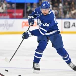 Dec 30, 2023; Toronto, Ontario, CAN; Toronto Maple Leafs forward Auston Matthews (34) shoots the puck against the Carolina Hurricanes in the first period at Scotiabank Arena. Mandatory Credit: Dan Hamilton-Imagn Images