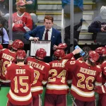 Apr 9, 2022; Boston, MA, USA; Denver Pioneers head coach David Carle talks with his team during a timeout during the third period of the 2022 Frozen Four college ice hockey national championship game against the Minnesota State Mavericks at TD Garden. Mandatory Credit: Brian Fluharty-Imagn Images