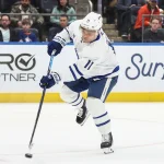 Apr 9, 2026; Elmont, New York, USA; Toronto Maple Leafs center Max Domi (11) attempts a shot on goal in the third period against the New York Islanders at UBS Arena. Mandatory Credit: Wendell Cruz-Imagn Images