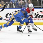 Nov 4, 2023; St. Louis, Missouri, USA; St. Louis Blues center Robert Thomas (18) battles Montreal Canadiens right wing Cole Caufield (22) during the first period at Enterprise Center.