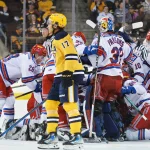 Erie Otters forward Malcolm Spence, center, skates by Kitchener Rangers teammates as they celebrate a 4-3 overtime win to end an Ontario Hockey League Western Conference quarterfinal game at Erie Insurance Arena in Erie on April 2, 2024.