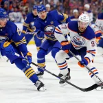Mar 9, 2024; Buffalo, New York, USA; Edmonton Oilers center Connor McDavid (97) looks to make a pass as Buffalo Sabres defenseman Owen Power (25) defends during the first period at KeyBank Center. Mandatory Credit: Timothy T. Ludwig-Imagn Images