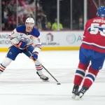 Dec 14, 2025; Montreal, Quebec, CAN; Edmonton Oilers forward Connor McDavid (97) plays the puck as Montreal Canadiens defenseman Noah Dobson (53) defends during the first period at the Bell Centre. Mandatory Credit: Eric Bolte-Imagn Images