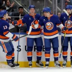 Mar 30, 2026; Elmont, New York, USA; New York Islanders center Brayden Schenn (10) celebrates his goal against the Pittsburgh Penguins with center Mathew Barzal (13) and center Calum Ritchie (64) and defenseman Carson Soucy (4) during the second period at UBS Arena.