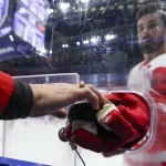 Apr 13, 2026; Tampa, Florida, USA; Detroit Red Wings center Dylan Larkin (71) gives a puck to a fan before a game against the Tampa Bay Lightning at Benchmark International Arena.