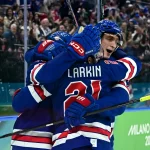 [US, Mexico  Canada customers only] Feb 18, 2026; Milan, Italy; Dylan Larkin of United States celebrates with teammates after scoring their first goal against Sweden in a men's ice hockey quarterfinal during the Milano Cortina 2026 Olympic Winter Games at Milano Santagiulia Ice Hockey Arena.