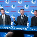 May 14, 2026; Vancouver, BC, Canada; The Vancouver Canucks promoted Henrik Sedin (left) and his twin brother Daniel Sedin (center) to co-presidents and Ryan Johnson (right) was named the Canucks new general manger during a press conference at Rogers Arena.