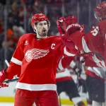 Jan 7, 2025; Detroit, Michigan, USA; Detroit Red Wings center Dylan Larkin (71) receives congratulations from teammates after scoring in the first period against the Ottawa Senators at Little Caesars Arena.