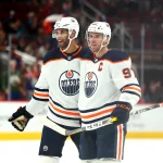 Oct 21, 2021; Glendale, Arizona, USA; Edmonton Oilers center Connor McDavid (97) and defenseman Darnell Nurse (25) against the Arizona Coyotes at Gila River Arena.