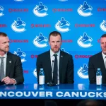 May 14, 2026; Vancouver, BC, Canada; Henrik Sedin and Ryan Johnson listen Daniel Sedin speak during a press conference where the Vancouver Canucks name new senior management staff. Henrik Sedin and his twin brother Daniel Sedin have been appointed as co-presidents of hockey operations and Ryan Johnson is now the new general manager of the club at Rogers Arena.