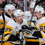 Oct 23, 2025; Sunrise, Florida, USA; Pittsburgh Penguins center Sidney Crosby (87) celebrates with defenseman Erik Karlsson (65) after scoring against the Florida Panthers during the third period at Amerant Bank Arena.