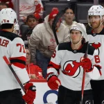 Apr 11, 2026; Detroit, Michigan, USA; New Jersey Devils center Jack Hughes (86) receives congratulations from teammates after scoring in the first period against the Detroit Red Wings at Little Caesars Arena.