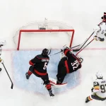 Jun 11, 2026; Raleigh, North Carolina, USA; Carolina Hurricanes goaltender Brandon Bussi (32) freezes the puck against Vegas Golden Knights center Tomas Hertl (48) during the third period in game five of the 2026 Stanley Cup Final at Lenovo Center.