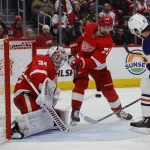 Jan 11, 2024; Detroit, Michigan, USA; Detroit Red Wings center Dylan Larkin (71) clears the puck form in front of Detroit Red Wings goaltender Alex Lyon (34) in the third period at Little Caesars Arena.