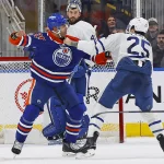 Feb 3, 2026; Edmonton, Alberta, CAN; Edmonton Oilers defensemen Darnell Nurse (25) and Toronto Maple Leafs defensemen Brandon Carlo (25) fight during the second period at Rogers Place.