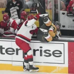 Jun 14, 2026; Las Vegas, Nevada, USA; Carolina Hurricanes defenseman Alexander Nikishin (21) boards Vegas Golden Knights center Colton Sissons (10) during the second period in game six of the 2026 Stanley Cup Final at T-Mobile Arena.