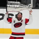 Jun 14, 2026; Las Vegas, Nevada, USA; Carolina Hurricanes center Jordan Staal (11) raises the the Stanley Cup after the win against the Vegas Golden Knights in game six of the 2026 Stanley Cup Final at T-Mobile Arena.