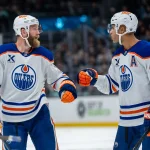 Oct 25, 2025; Seattle, Washington, USA; Edmonton Oilers defenseman Mattias Ekholm (14) and defenseman Darnell Nurse (25) celebrate after a goal during the third period against the Seattle Kraken at Climate Pledge Arena.