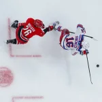 Dec 29, 2025; Raleigh, North Carolina, USA; New York Rangers center Vincent Trocheck (16) skates with the puck against Carolina Hurricanes defenseman Sean Walker (26) during the first period at Lenovo Center.