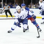 Apr 17, 2025; New York, New York, USA; Tampa Bay Lightning center Brayden Point (21) and New York Rangers center Vincent Trocheck (16) chase after the puck in the third period at Madison Square Garden.