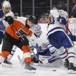 Jan 7, 2025; Philadelphia, Pennsylvania, USA; Philadelphia Flyers right wing Matvei Michkov (39) battles for the puck against Toronto Maple Leafs center John Tavares (91), goaltender Joseph Woll (60) and defenseman Morgan Rielly (44) during the third period at Wells Fargo Center.
