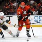 May 14, 2026; Anaheim, California, USA; Anaheim Ducks defenseman John Carlson (74) fights for the puck against Vegas Golden Knights center Jack Eichel (9) during the third period of game six of the second round of the 2026 Stanley Cup Playoffs at Honda Center.