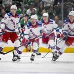 Apr 11, 2026; Dallas, Texas, USA; New York Rangers defenseman Will Borgen (17) and center Vincent Trocheck (16) and New York Rangers defenseman Braden Schneider (4) and right wing Jaroslav Chmelar (49) face the Dallas Stars attack during the first period at the American Airlines Center.