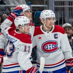 Mar 12, 2025; Seattle, Washington, USA; Montreal Canadiens forward Cole Caufield (13) forward Juraj Slafkovský (20) and forward Nick Suzuki (14) celebrate a goal during the second period against the Seattle Kraken at Climate Pledge Arena.