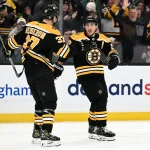 Mar 9, 2023; Boston, Massachusetts, USA; Boston Bruins left wing Brad Marchand (63) celebrates with center Patrice Bergeron (37) after scoring a goal against the Edmonton Oilers during the first period at the TD Garden.