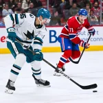 14 mars 2026 ; Montréal, Québec, Canada ; le défenseur des Sharks de San Jose, Shakir Mukhamadullin (85), joue la rondelle contre le centre des Canadiens de Montréal, Jake Evans (71), durant la deuxième période au Centre Bell.
